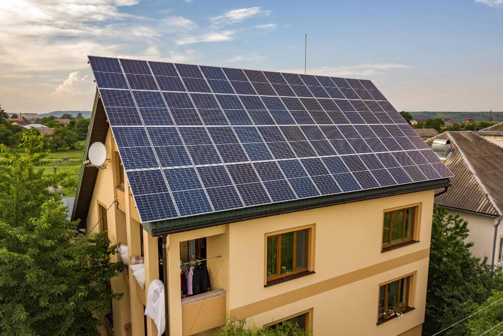 Solar Panel Installation in Ghana-aerial top view new modern residential house cottage with blue shiny solar