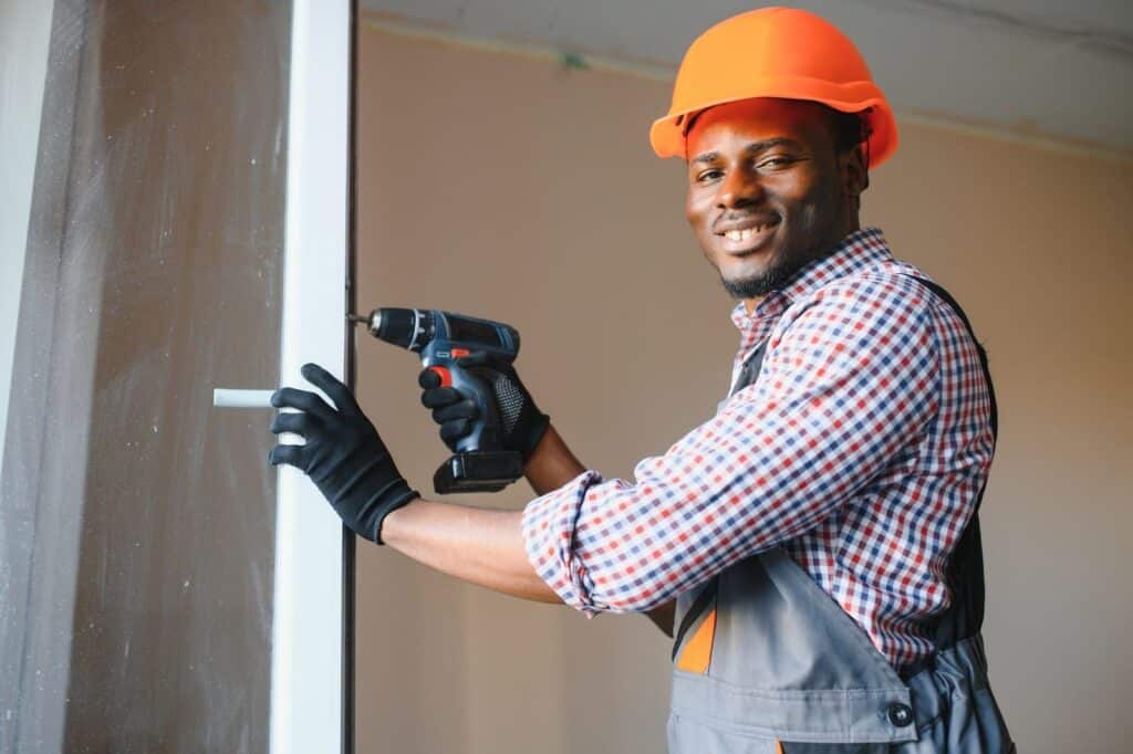 african american workman in overalls installing, Common mistakes in solar panel installation
